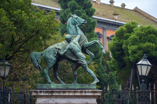Clodt horses sculpture in front of the garden of Royal Palace in Naples, Italy