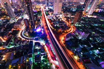 Fototapeta na wymiar Night View of Cityscape of downtoen in Bangkok , Thailand . Beautiful of steet light from long explosure technicque present amazine night view in City