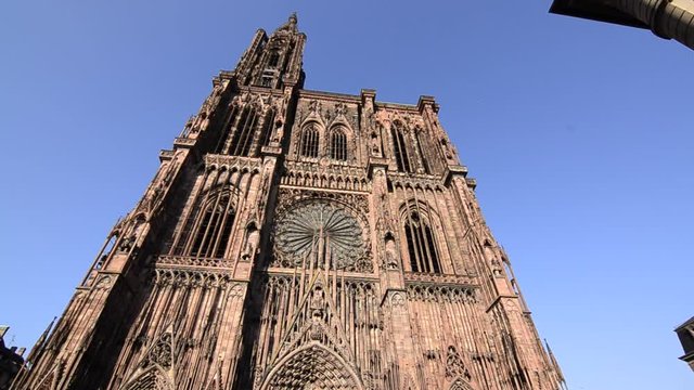 Strasbourg, France.August 2019. Our Lady's magnificent cathedral, with its 142 meters of height, was for comparison time for taller buildings. The reddish fa&ccedil;ade is impressive. Pan movement.