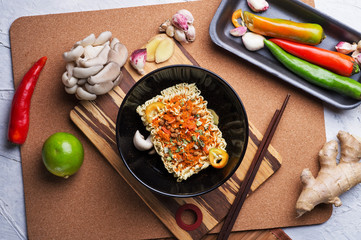 cooking spicy instant noodles soup with shrimps and  mushrooms. flat lay.
