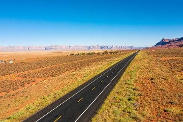 Fototapeta na wymiar Aerial view of Arizona nature. Highway road, orange landscape, blue sky. Arizona state. USA country