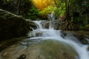 Fototapeta premium A beautiful waterfall deep in the tropical forest steep mountain adventure in the rainforest.