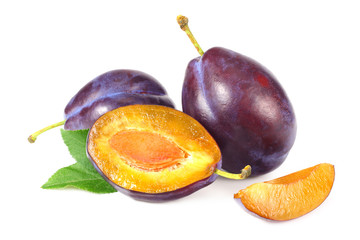 fresh plum fruit with green leaf and cut plum slices isolated on white background