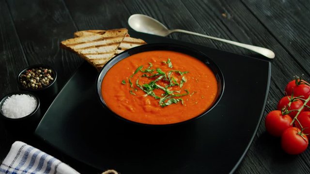 Tomato soup in bowl with crisp bread