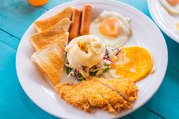 English breakfast - toast, egg, bacon and vegetables on blue wood table background