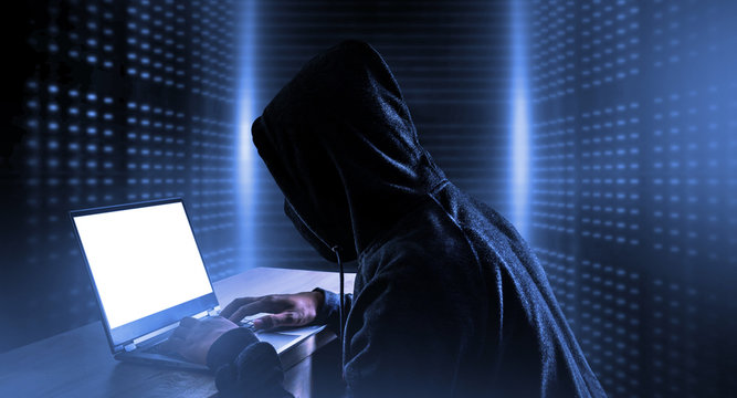 Cybercrime, hacking and technology crime. hacker with laptop.