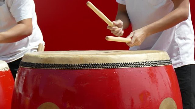 drummer playing big red drum