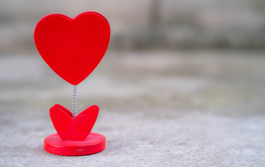 Fototapeta premium Selected Focus Image of Heart Stand Display on the Ground with Bokeh on the Back for Valentine Theme or Valentine Card