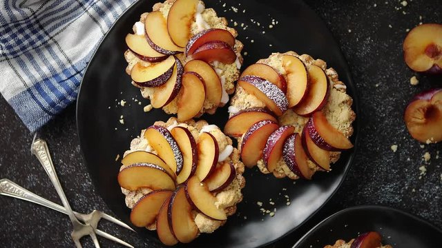 Delicious homemade mini tarts with fresh sliced plum fruit