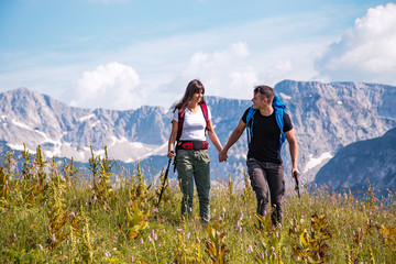 Obraz premium Hiking couple enjoying together in nature environment