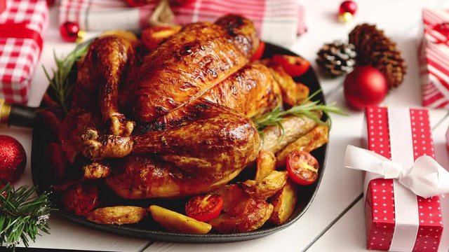 Roasted whole chicken or turkey served in iron pan with Christmas decoration