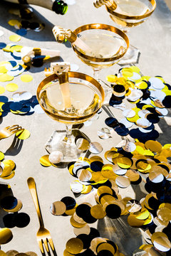 Champagne party 2020 new year conceptual image, elegant glass of champagne with a bottle , top view, hard light, christmas decoration, strong shadow.