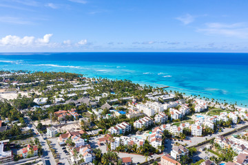 Caribbean city on tropical coastline. Aerial view from drone