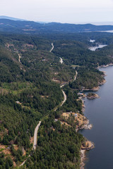 Sunshine Coast, British Columbia, Canada. Aerial View of a windy highway on the coast during a sunny and hazy summer morning.