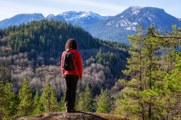 Adventurous Girl Hiking in the mountains during a sunny Autumn Evening. Taken Squamish, North of Vancouver, British Columbia, Canada.