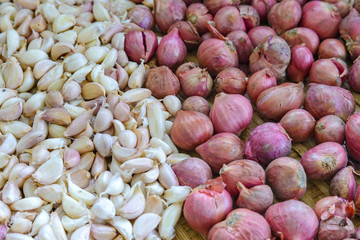 Top view of pile of fresh clove garlic and purple onions