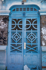 Antique blue door. Entrance with vintage blue door with metal grid on glass at the street in Rio de Janeiro, Brazil