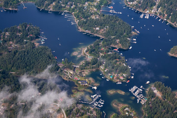 Sunshine Coast, British Columbia, Canada. Aerial View of Beaver Island and Madeira Park during a sunny and hazy summer morning.