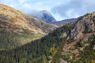 Skagway, Alaska, United States of America. Beautiful Natural American Mountain Landscape View during a cloudy and sunny summer morning.