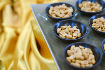 peanut in black bowl on buffet easily to take