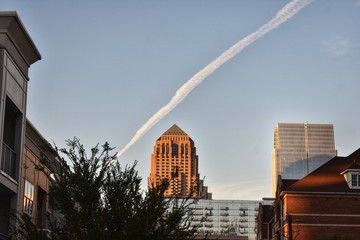 Chemtrail in the sky over various buildings 