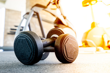 Dumbbell on the floor in luxury fitness club at the morning , Concept for healthy lifestyle