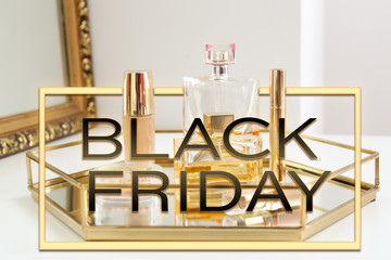 Tray with makeup cosmetics and bottles of perfumes on dressing table. Black Friday sale