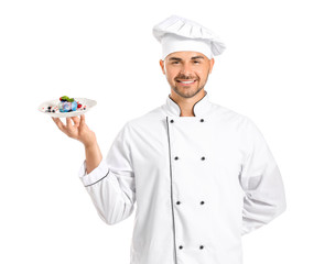 Male confectioner with tasty dessert on white background