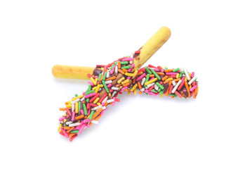 Biscuit stick bread with sweet colorful chocolate isolated on white background