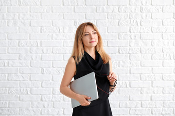 Portrait of stylish mature businesswoman with laptop on white background