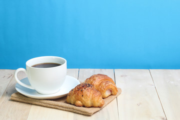 Croissant and coffee   on wood table