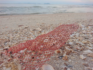 Net fishing wastes on the beach has sand pollutants that damage the environmental and humans 