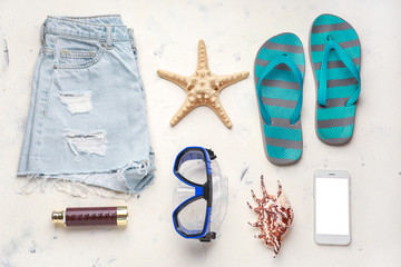 Composition with beach accessories on light background