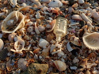 Brocken Glass wastes on the beach has sand pollutants that damage the environmental and humans 