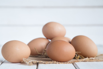 Eggs chicken on white wood background