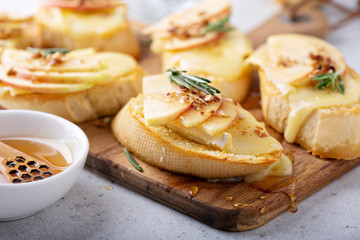 Pear and brie crostini with honey, pecan and rosemary, New Years Eve or Christmas party appetizer