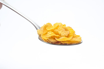 Cornflakes on spoon  isolated on white background