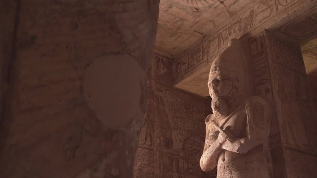 Acending shot inside Abu Simbel of a big Osiris statue.