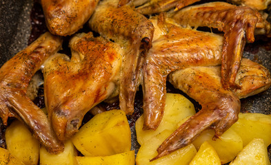 Fried chicken wing with potatoes, food.