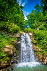 Fototapeta na wymiar Beautiful landscape with waterfall in the mountain