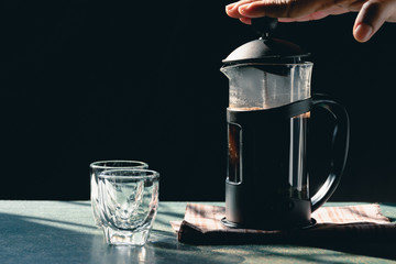 Aromatic coffees in French press coffee maker with couple glass and Antique coffee bean grinder using hand crank,Hot drink is good for health,Wood table,Black background,Natural light,Healthy Eating.