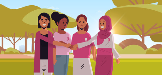 women with pink ribbons holding hands mix race girls standing together breast cancer day disease awareness and prevention concept summer park landscape background flat portrait horizontal vector