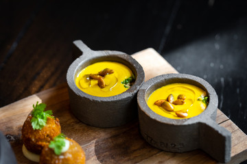 Haute cuisine - noodles with oysters filled by freezy ozone , croutons and yellow sauce on a wooden...