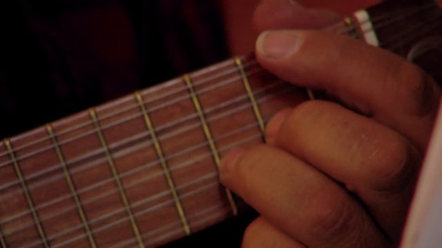 Male Hands playing a Bolivian guitar called, Charango, in La Paz, Bolivia. Close-Up. 