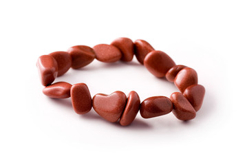 Bracelet of polished goldstone (glass material) with sparkling metalic flakes including a heart-shaped bead.