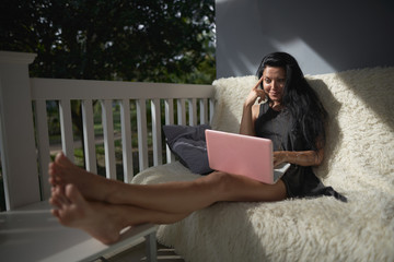              freelance girl sitting on the balcony working     