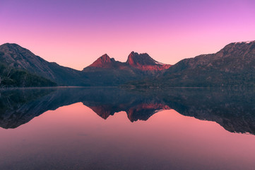 Picturesque nature background with Cradle Mountain and lake at sunrise