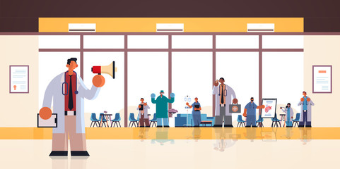 male doctor using loudspeaker making announcement for mix race hospital workers in uniform medicine healthcare concept modern clinic office interior full length flat horizontal vector illustration