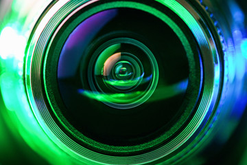 The camera lens and green backlighting. Green camera Lens close Up. Gorizontal photo