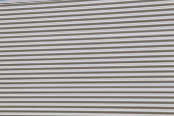 Fototapeta premium Wide shot of silver corrugated metal with bolts